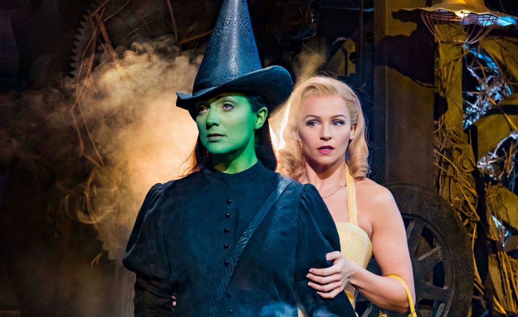 Glinda the Good Witch and Elphaba, the Wicked Witch Of The West on stage in costume
