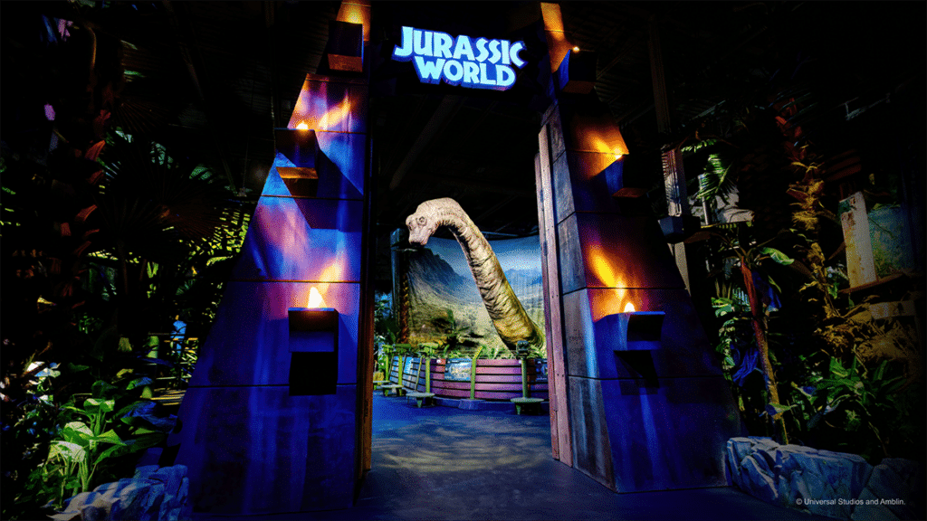 The doors to Jurassic World: The Experience, in Manchester, with a glimpse of a Brachiosaurus inside