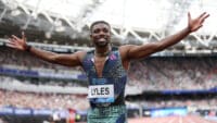 Noah Lyles celebrates a win in a packed stadium