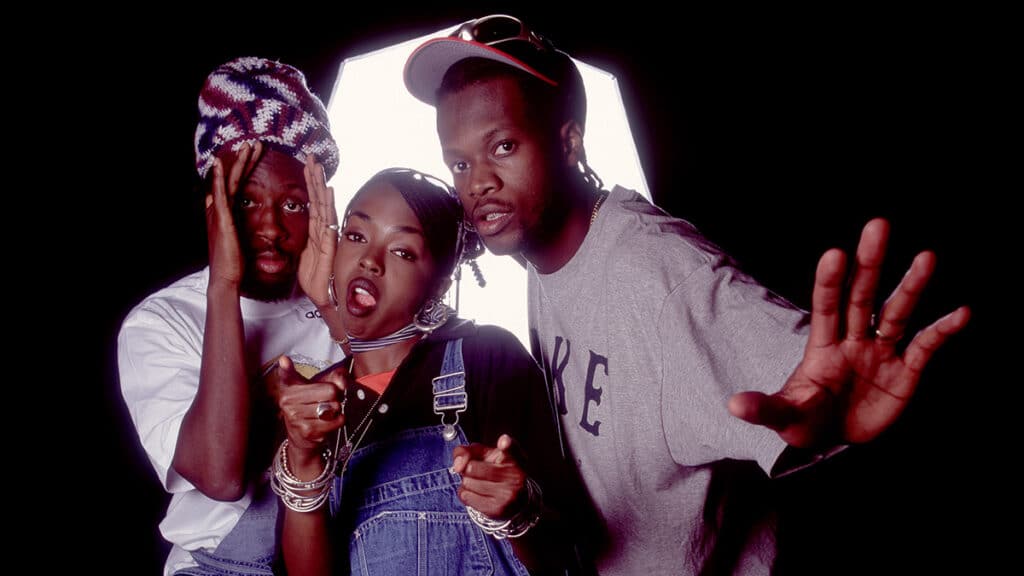 Portrait of American Hip Hop group Fugees as they pose backstage at the World Music Theater, Tinley Park, Illinois, August 6, 1996. Pictured are, from left, Wyclef Jean, Lauryn Hill, and Pras.