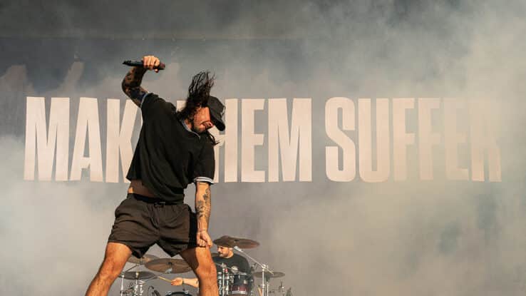 Sean Harmanis of Make Them Suffer on stage