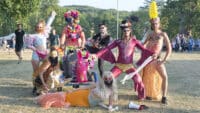 A group of performers at Wilderness festival wearing elaborate fancy dress outfits