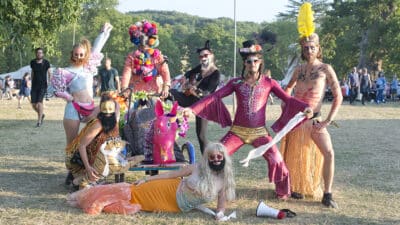 A group of performers at Wilderness festival wearing elaborate fancy dress outfits