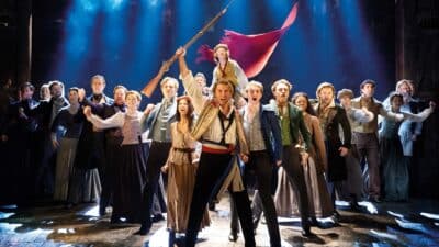 The ensemble of Les Miserables on stage