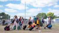 Festival goers arrive with their shopping and belongings at Reading Festival