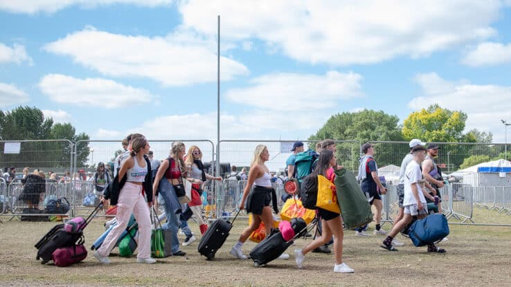 Festival goers arrive with their shopping and belongings at Reading Festival