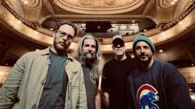 Turin Brakes look down at the camera from inside a theatre