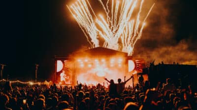 A crowd shot of All Points East Festival with fireworks behind the stage.