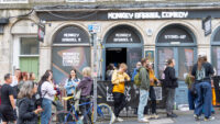 EDINBURGH, SCOTLAND - AUGUST 06: People queue up outside the Monkey Barrel Comedy Club during The Fringe festival on August 06, 2025 in Edinburgh, Scotland. Billed as the world's greatest platform for creative freedom, for three weeks each August, Edinburgh welcomes an explosion of creative energy from around the globe as artists and performers take part in the Edinburgh Fringe Festival, presenting shows that span many genres including cabaret, children's shows, comedy, dance, physical theatre, circus, music, musicals, opera and theatre. (Photo by Athanasios Gioumpasis/Getty Images)