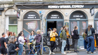 EDINBURGH, SCOTLAND - AUGUST 06: People queue up outside the Monkey Barrel Comedy Club during The Fringe festival on August 06, 2025 in Edinburgh, Scotland. Billed as the world's greatest platform for creative freedom, for three weeks each August, Edinburgh welcomes an explosion of creative energy from around the globe as artists and performers take part in the Edinburgh Fringe Festival, presenting shows that span many genres including cabaret, children's shows, comedy, dance, physical theatre, circus, music, musicals, opera and theatre. (Photo by Athanasios Gioumpasis/Getty Images)