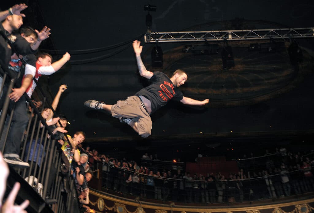 A fan dives from the first floor of the Metro in Melbourne Australia during a Parkway Drive show
