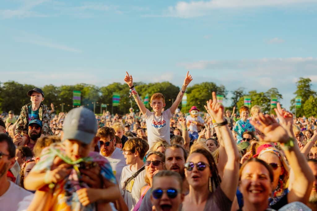 A sunny shot of families in the crowd enjoying Gone Wild Festival.