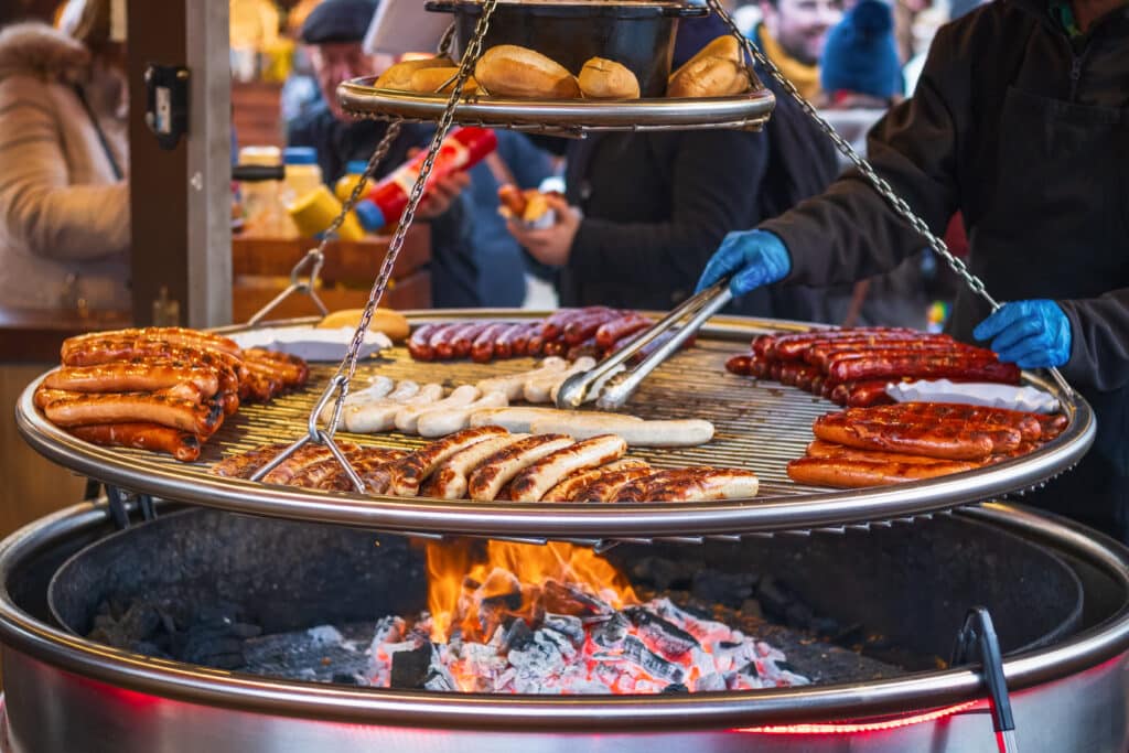 Sausages on barbecue grill at a food stall during a London festival