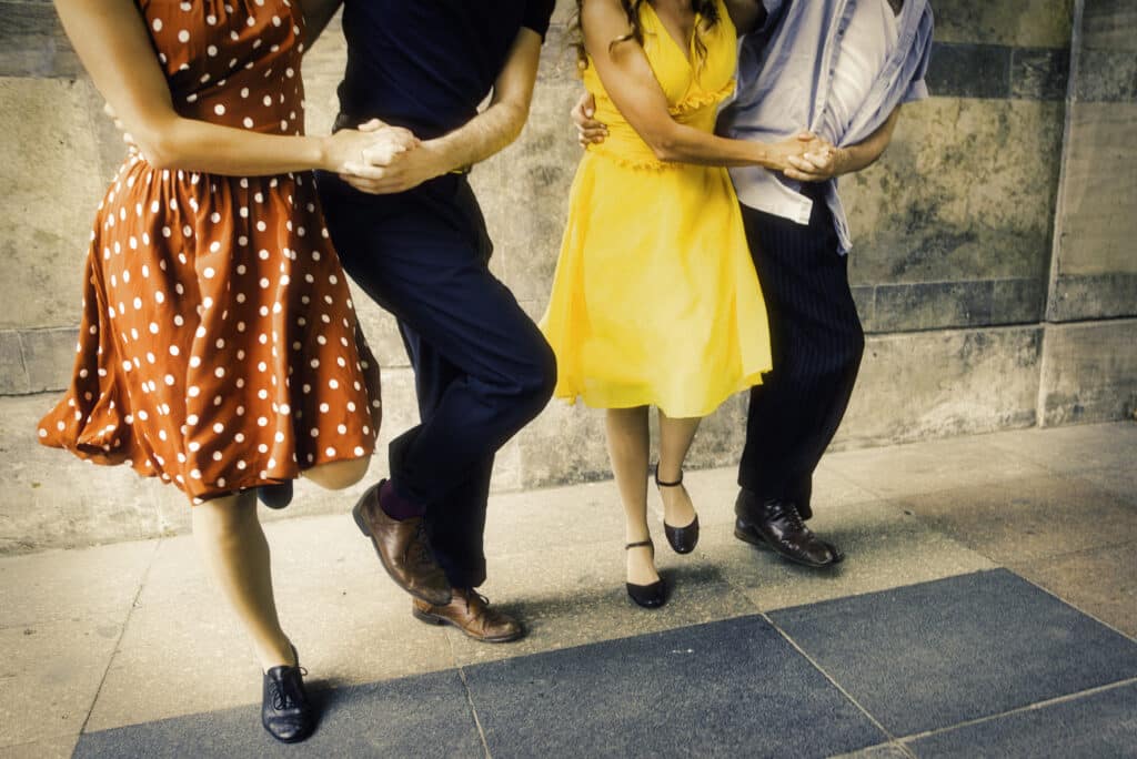 Two couples dancing the Lindy Hop