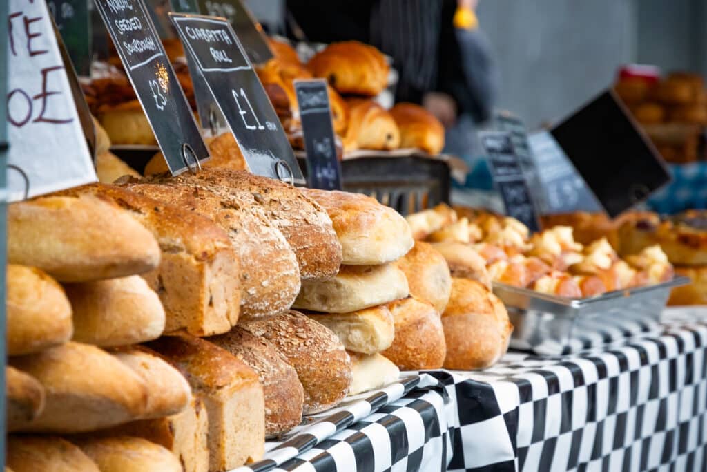 Fresh sourdough breads on display at an outdoor food market