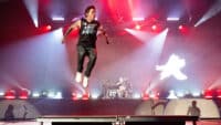 Pierre Bouvier of Simple Plan leaps onstage at Bill Graham Civic Auditorium on August 12, 2025 in San Francisco, California.