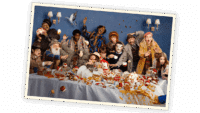 The cast of Paddington The Musical seated at a chaotic and messy dinner table
