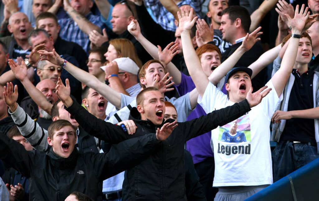 Millwall fans goad the West Ham fans (Photo by Ella Ling/AMA/Corbis via Getty Images)