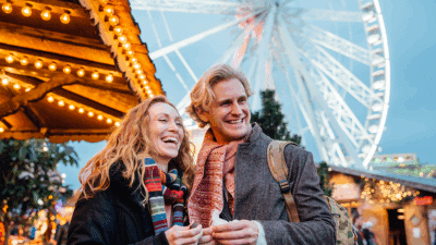 A happy couple at a Christmas market in London