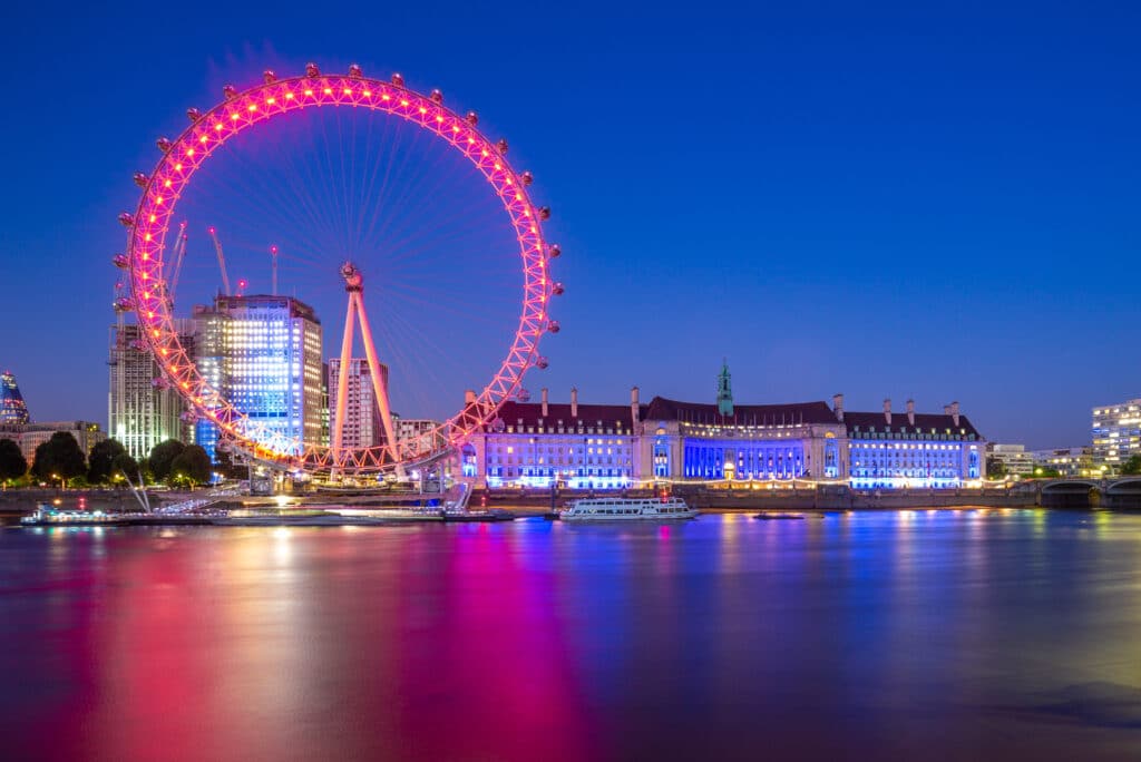 The London Eye illuminated pink in the early evening