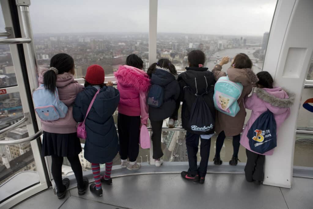 Schoolchildren looking at the view from one of the pods on the London Eye
