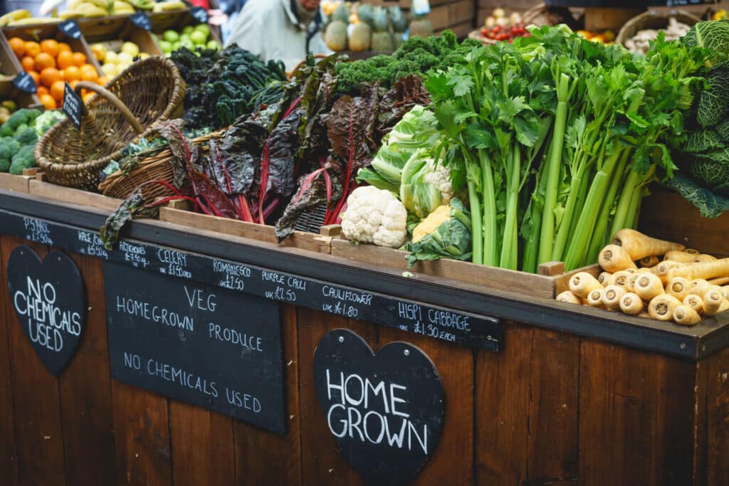 Vegetable stall in farmer market, including celery, parsnips and broccoli