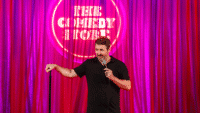 A comedian performing at The Comedy Store in London