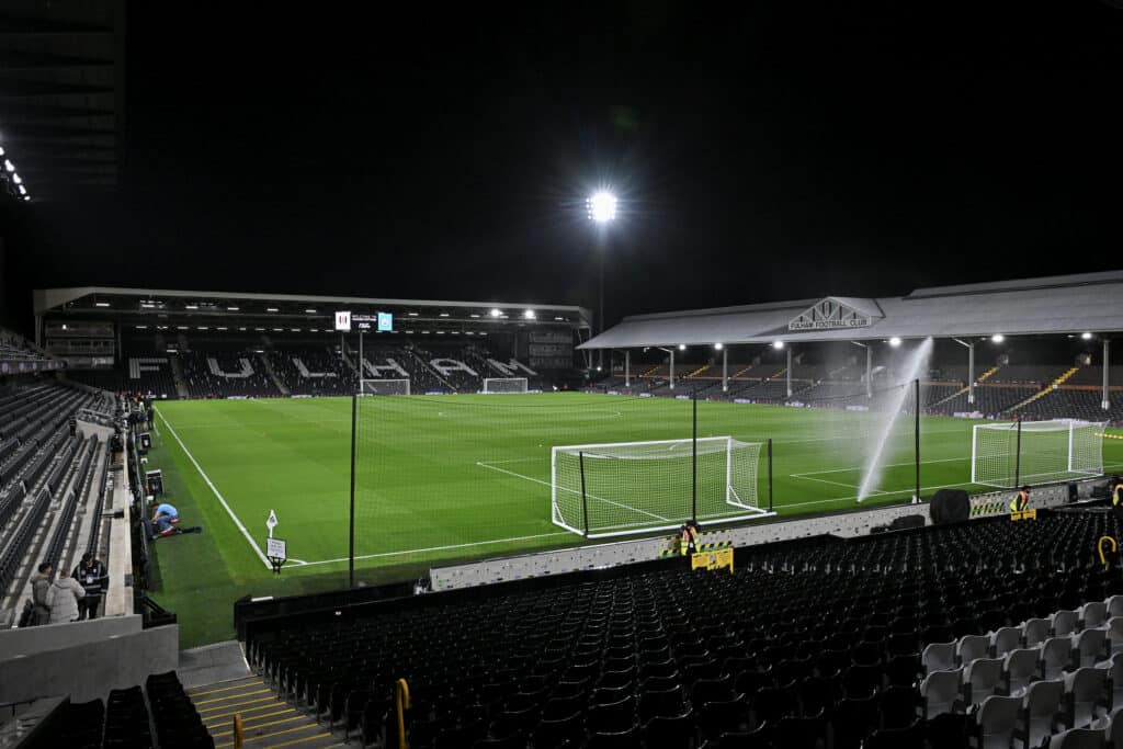 View from the stands at Craven Cottage at night, with a spotlight illuminating the pitch