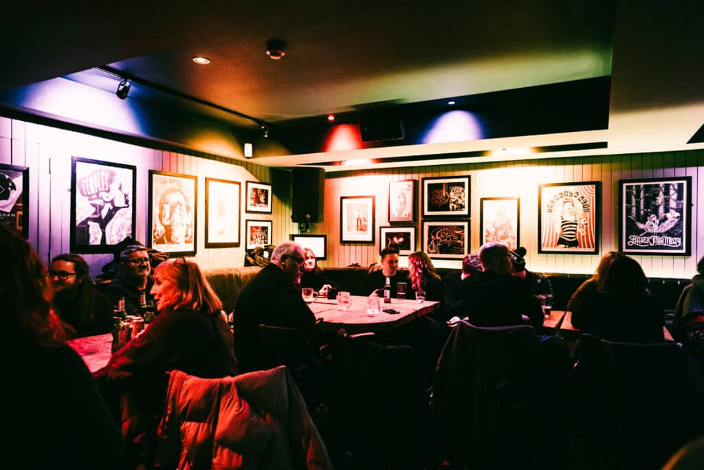 People relaxing and having drinks in King Tut's Wah Wah Hut in Glasgow, Scotland