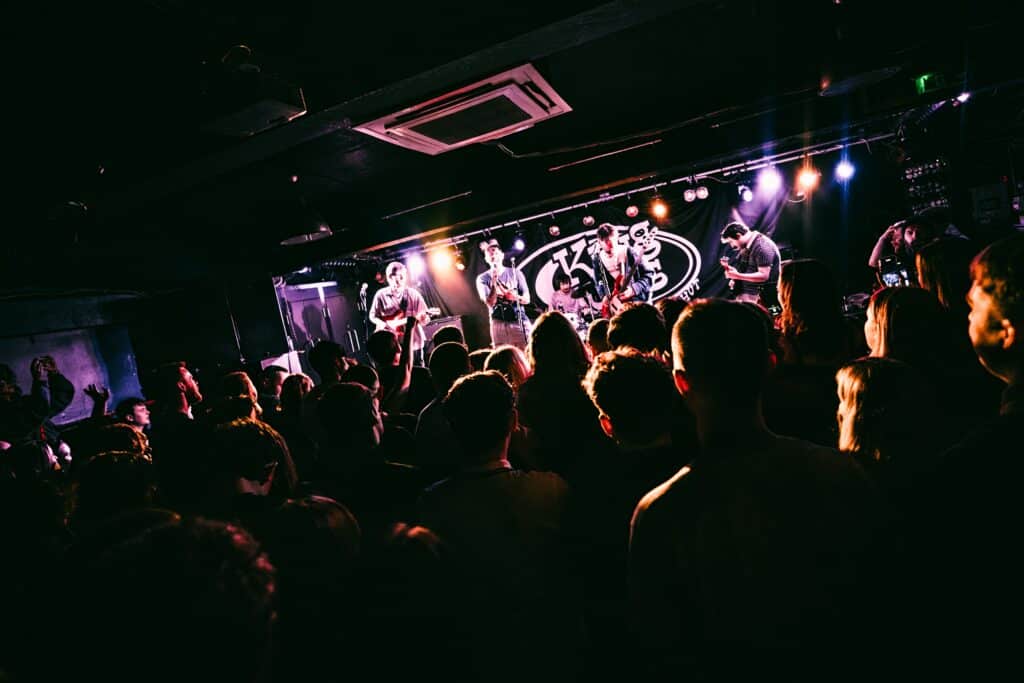 A band playing to a crowd of people at King Tut's Wah Wah Hut in Glasgow, Scotland