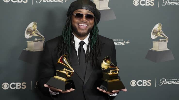 Leon Thomas poses with his two Grammy Awards