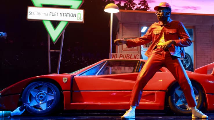 Tyler the Creator performing in front of a red car on the Grammy Stage 2026