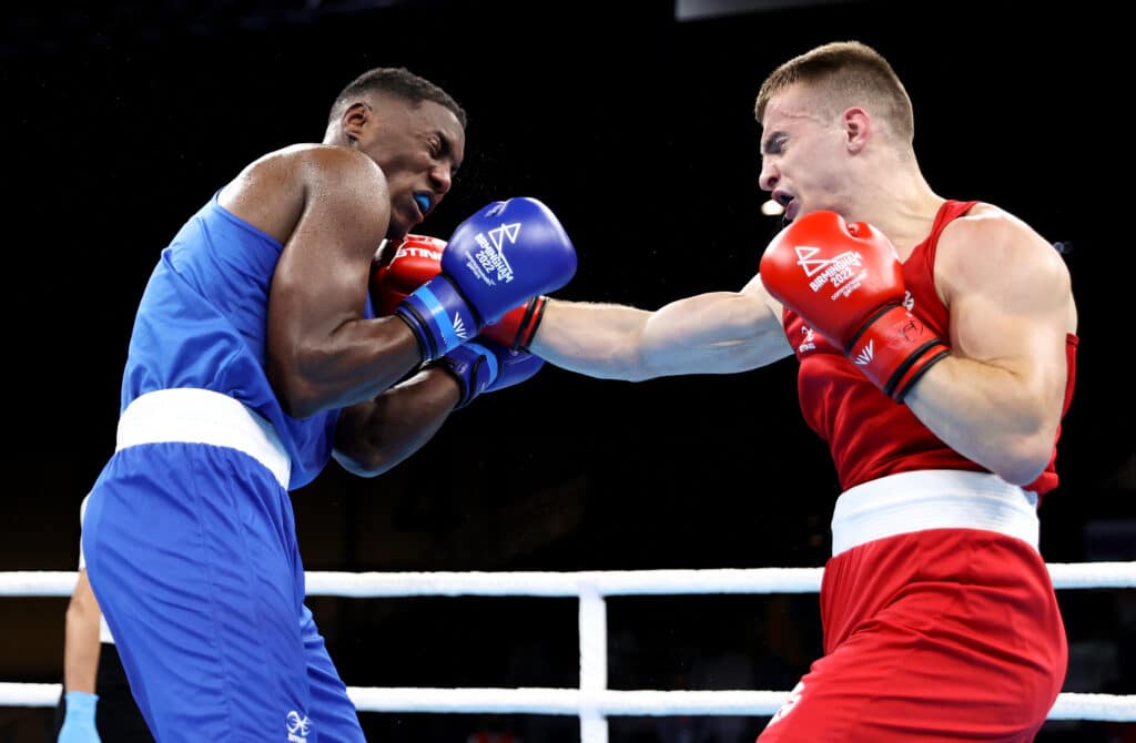 Sean Lazzerini of Team Scotland punches Jean Luc Rosalba of Team Mauritius during the Men’s Over 75kg-80kg (Light Heavyweight) - Round of 16 fight between Sean Lazzerini of Team Scotland and Jean Luc Rosalba of Team Mauritius on day four of the Birmingham 2022 Commonwealth Games at NEC Arena on August 01, 2022 on the Birmingham, England.