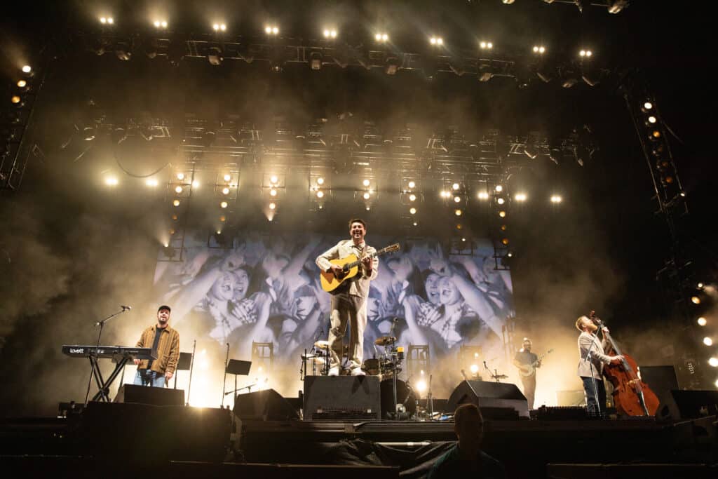 Ben Lovett, Marcus Mumford, and Ted Dwane of Mumford & Sons perform onstage