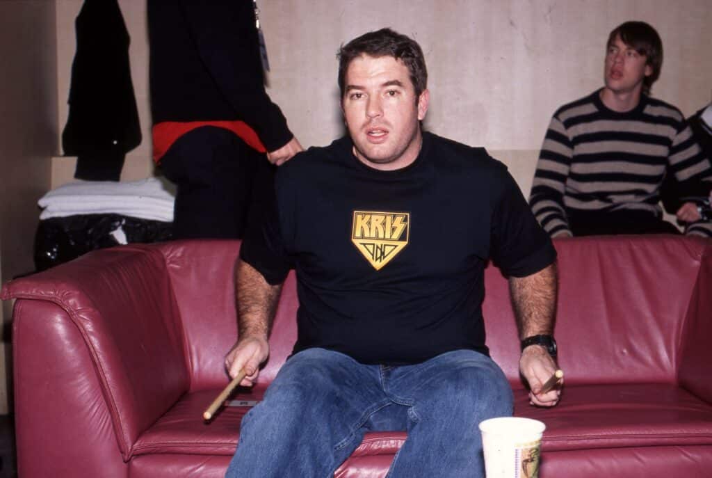 Zach Lind of Jimmy Eat World, around 2001, sitting on a sofa, drumming