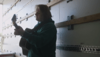 Lewis Capaldi plays the guitar backstage