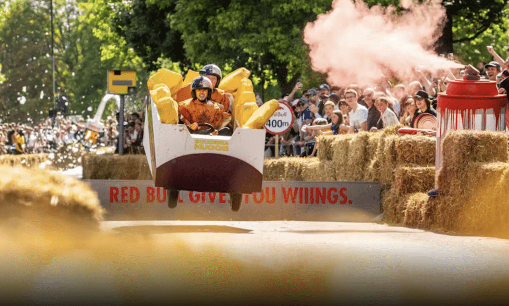 Two competitors racing in a cart that looks like a box of fries at the Red Bull Soapbox race