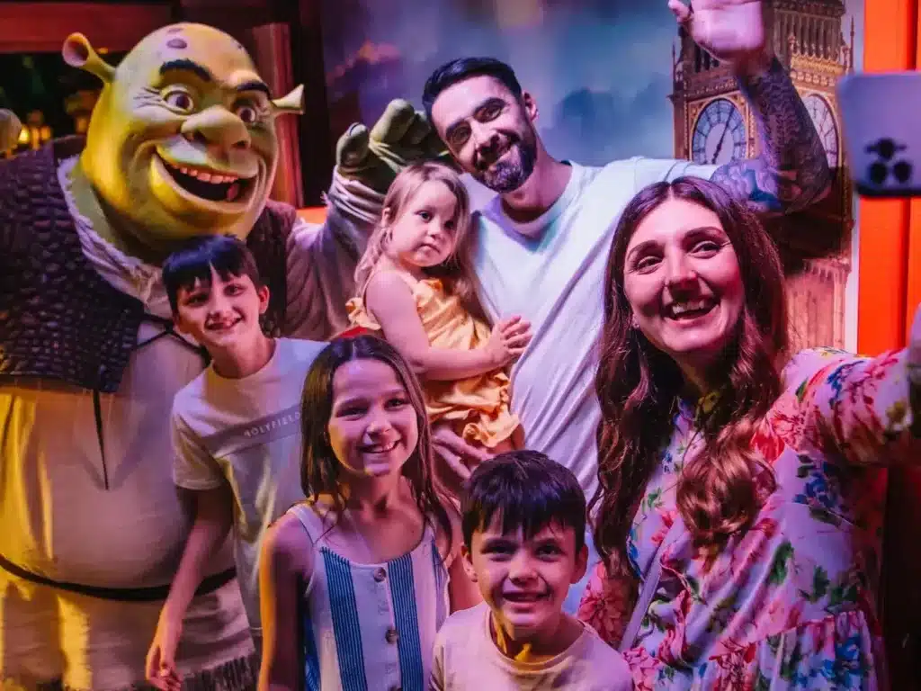 A family poses with Shrek at Shrek's Adventure in London 