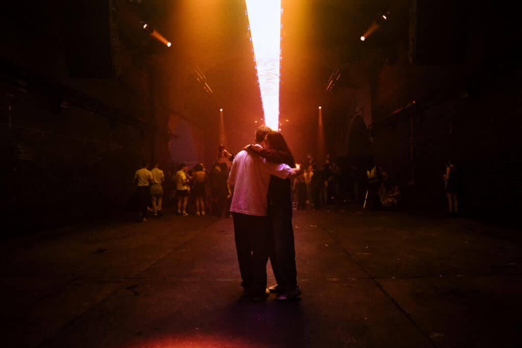 Clubers hug outside The Warehouse Project in Manchester