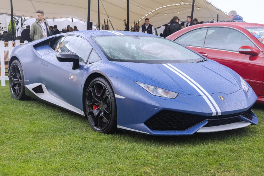 A blue Lamborghini Huracan Avio parked on grass at The London Concours