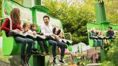 a family riding the Peter Rabbit Hippity Hop attraction in CBeebies Land at Alton Towers Resort