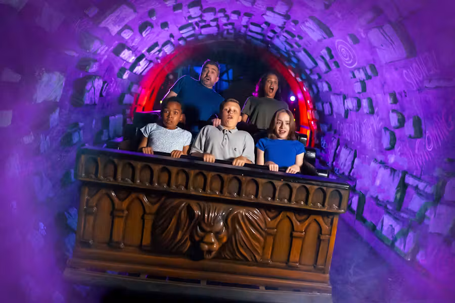 A family ride a moving cart at Alton Towers