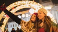 Girl friends having fun and enjoying on Christmas market
