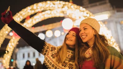 Girl friends having fun and enjoying on Christmas market