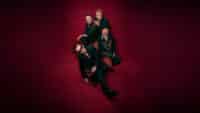U2, the band, all sit on the same armchair